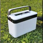 white portable battery bank in field of grass