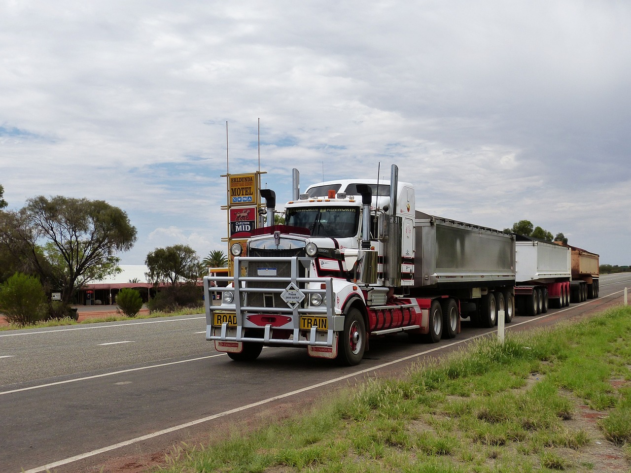 semi-truck and trailer parked on a road awaiting unloading